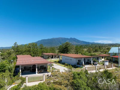 3-bedroom Home for sale in Alto Boquete with mountain views, fruit trees, fenced yard, and terraces. Gated community near downtown Boquete